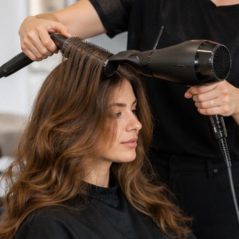 High quality portrait of a stylish female hair stylist, natural lighting, warm professional smile, modern salon background, elegant presentation